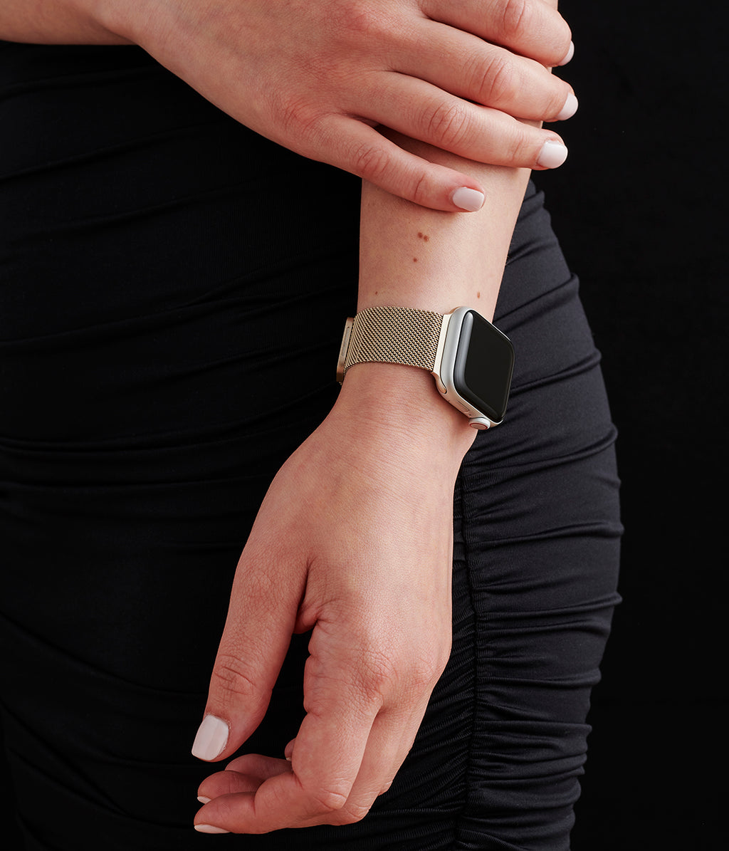 Close-up of a woman's wrist wearing an Apple Watch with a stylish, high-quality strap.